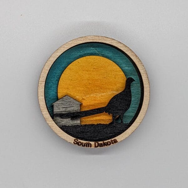 Custom wooden magnet depicting a Pheasant in front of the sun