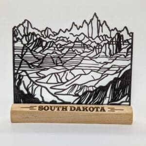 Custom wood continuous line sculpture of the Badlands with South Dakota text