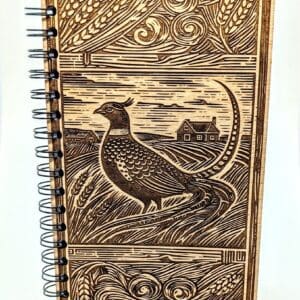 Wooden journal cover showing a pheasant on the praire