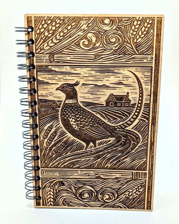 Wooden journal cover showing a pheasant on the praire