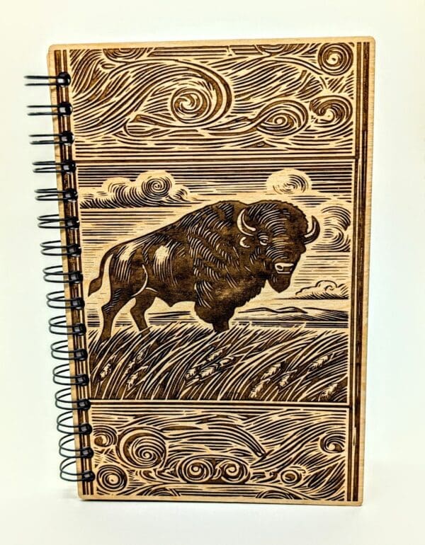 Wooden journal cover with a bison on the prairie