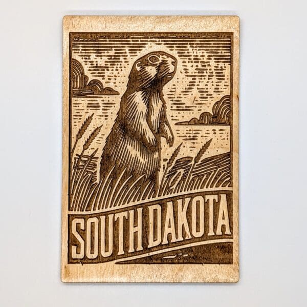 Wood carved postcard with a prairie dog and South Dakota