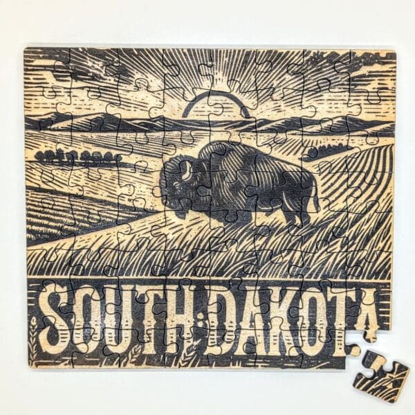 Wooden puzzle of a bison on a prairie vista in South Dakota