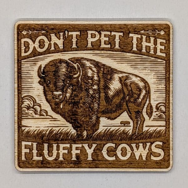 Wood magnet with a buffalo and don't pet the fluffly cows text