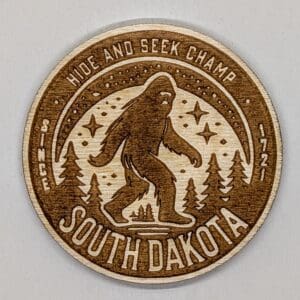 Wooden magnet of sasquatch with hide and seek champ and South Dakota text
