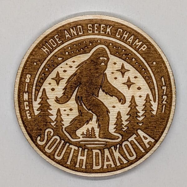 Wooden magnet of sasquatch with hide and seek champ and South Dakota text